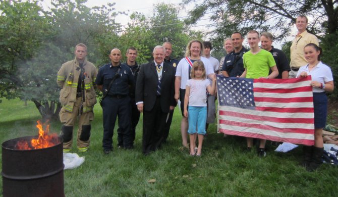 Members of the CAR, DAR and SAR retired worn and soiled United States flags with assistance of the Great Falls Volunteer Fire Department. Worn American flags of any size may be left at the Great Falls Library year-round for this annual event. 