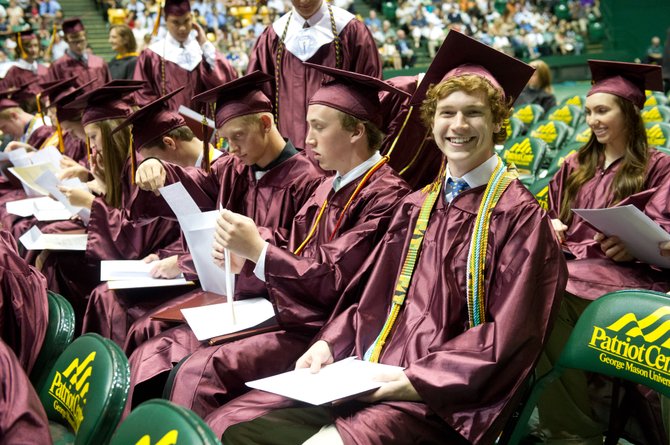 Max Harrison is all smiles holding his freshly minted Oakton High School diploma during the June 19 graduation ceremony held at the George Mason University Patriot Center.

