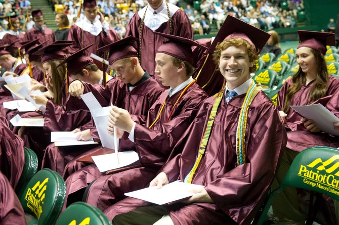 Max Harrison is all smiles holding his freshly minted Oakton High School diploma during the June 19 graduation ceremony held at the George Mason University Patriot Center.

