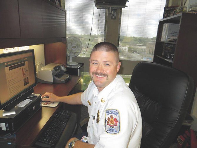 Capt. Bill Moreland is back at his desk at Fire Department headquarters after helping rescue a woman from a Centreville townhouse fire.
