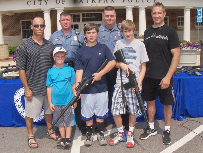 Back row, from left are Bill Wilkinson, SRO Mike Murphy, Sgt. Kyle Penman and Stan Tomajko; with (front row, from left) brothers Eric and Brady Wilkinson and Jordan Tomajko. Brady and Jordan are holding their replica rifles.