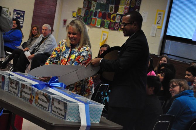 From left, Lisa Lombardozzi, president of LINK, and Marty Smith, Cluster One assistant superintendent
for Fairfax County Public Schools, cut the ribbon on the new food donation bins at Dranesville Elementary School Monday, March 12. The school now donates unused food and beverages to LINK