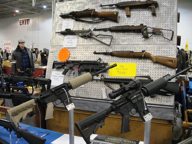 Guns on display at the Nation’s Gun Show. Private owners of guns in Virginia are not required to conduct background checks before selling firearms.
