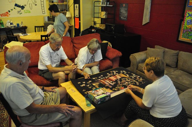 Members at the Memory Café at Andrew Chapel United Methodist Church work on a puzzle, which aims to help the patients and caregivers suffering from dementia, Alzheimer’s and other diseases, 