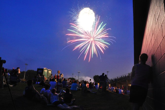 The audience watches fireworks from the bleachers at Langley High School Wednesday, July 4. 