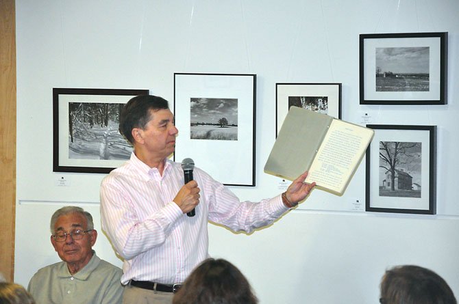 Chuck Veatch, who worked with Robert Simon during the original construction of Lake Anne and Reston, shows his sales manual that he received upon being hired by Simon in 1964. 