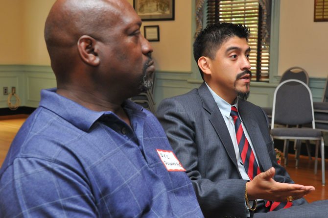 Ulycess “Dee” Dunmore, left, listens as and Fernando Torrez poses a question to Tim Kaine during a veterans roundtable at Post 24 of the American Legion in Old Town.