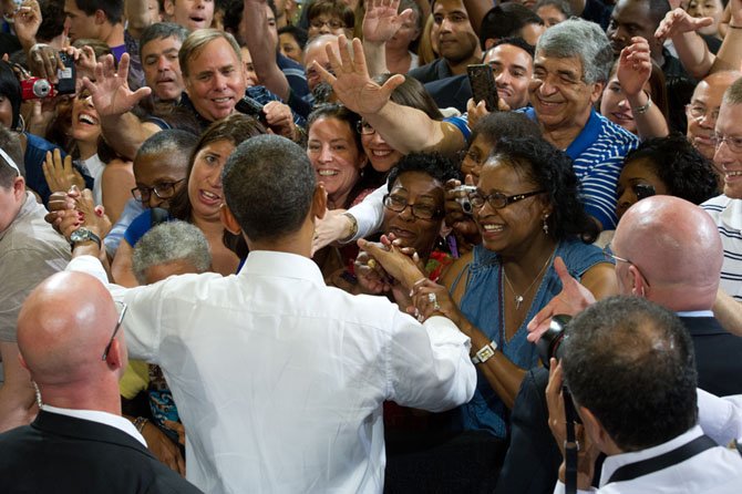 President’s arrival is greeted with cheers and applause.