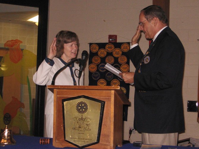 Jan Auerbach, the Rotary of McLean new president, takes oath of office from Steve Cook, Rotary District Governor.