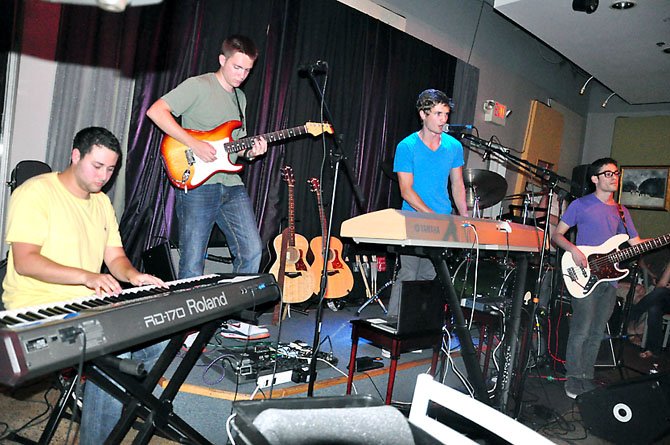 From left, Xander Green, Matt Brown, A.J. Smith and Lloyd Kikoler perform at  Cafe Montmartre in Reston Friday, July 13. Smith, a Herndon native, was recently awarded a scholarship at NYU, where he is a junior, for his songwriting. 