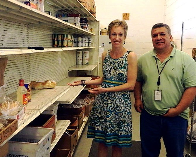 Niki Wanner shows off UCM’s empty shelves. With her is food pantry manager Jose Fratti.

