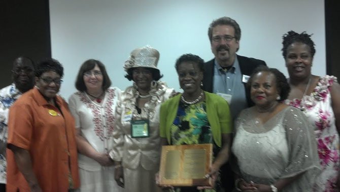 At the Virginia Conference, the Rising Hope delegation receives the Bishop Leontine Kelly Peace and Justice Award. From left are Gerald and Barbara Warren, Kay Barnes, Mary Baker, Yvonne Cunningham (holding plaque), the Rev. Keary Kincannon, Sula Tyler and Jacqueline Martin. 
