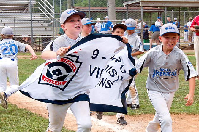 Alec Reilly and teammates take the winner’s banner on a victory lap. West Springfield Little League 9-10 American All-Stars head to states.