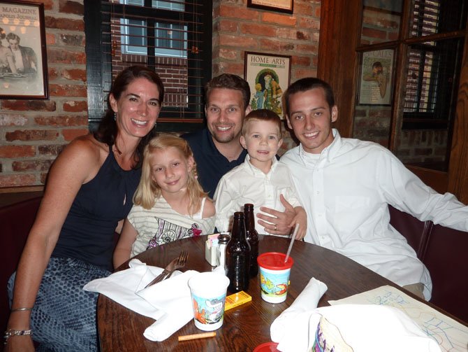 Alexandria Aces pitcher Steven Schulter, right, enjoys the Meet the Aces dinner with his host family, Jonelle and Henry Wallmeyer and Mary Francis, 6, and Nicklaus, 4.