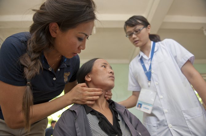 Dermatologist Lt. Cmdr. Josephine Nguyen, of Burke, checks a Vietnamese patient’s throat at a Medical Civil Actions Project (MEDCAP) July 16 as part of Pacific Partnership 2012. 