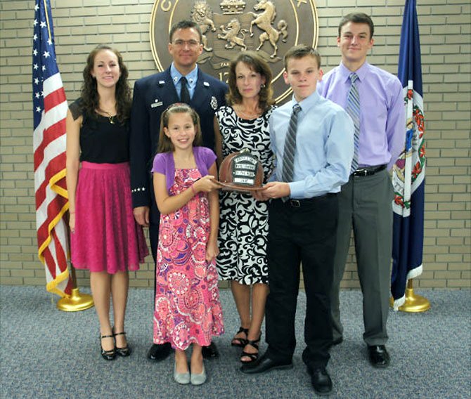 Robert L. Upchurch insisted that his whole family deserved the Firefighter of the Year Award. From left: Jenny, 19, Master Technician Robert Upchurch, Mrs. Lynde Upchurch, Jesse, 18. Front: Julie, 11 and Jason, 14, hold the prized leather helmet award.