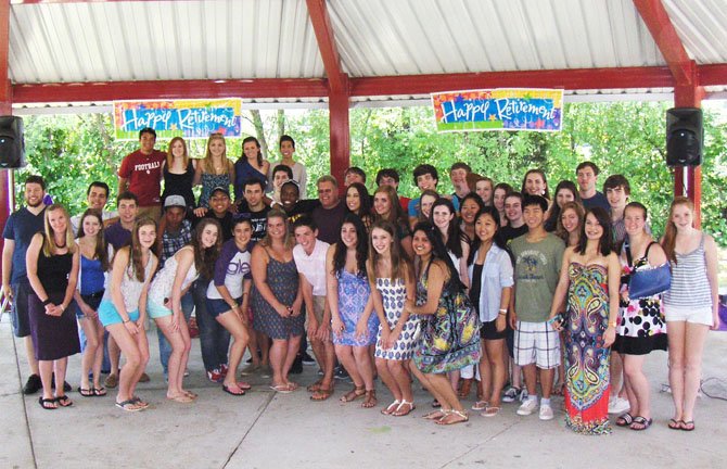 Choral students gather around retired Chantilly Choral Director Glenn Cockrell (middle row, center) for a photo.