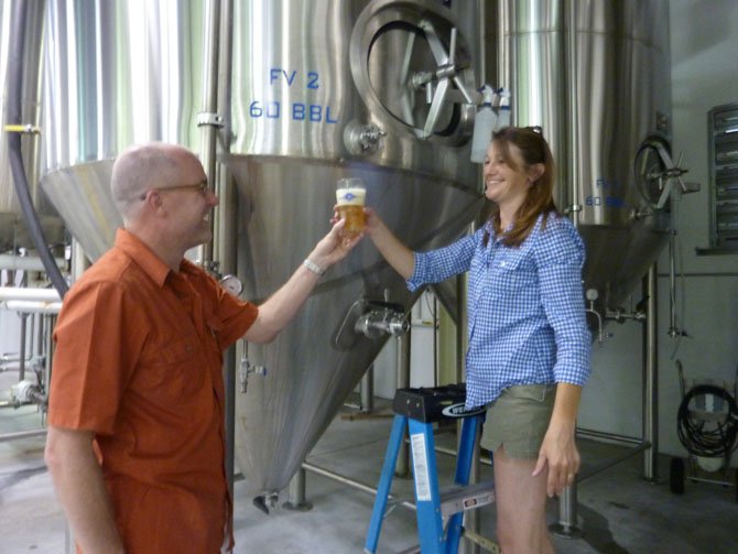 Alexandria's John Bordner, left, gets a sneak preview of Port City Brewing's new Derecho Common beer from tasting room manager Jennifer Chace. The limited edition beer will be officially tapped Aug. 3 at 3 p.m.