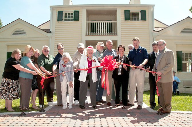 From left, Holly Doughtery, Executive Director of the Mount Vernon-Lee Chamber of Commerce; Susan Escherich, and Carolyn Gamble, Friends of Historic Huntley; Mason District Park Authority Board Member Frank Vajda; Braddock District Representative on the Park Authority Board Tony Vellucci; Norma Hoffman, Friends of Historic Huntley; Lee District Park Authority Board Member Edward Batten; Barbara Ballentine, President of the Friends of Historic Huntley; members of the Amlong Family (previous owners); Chairman Sharon Bulova, Fairfax County Board of Supervisors; Charlie Davis, Friends of Historic Huntley; Lee District Supervisor Jeff McKay; Tim Aiken, Legislative Director for Rep. Jim Moran; and State Delegate Mark Sickles.