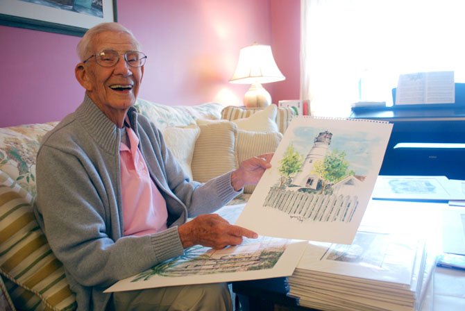 Kenneth Bud Aldrich shows a lighthouse watercolor that he painted.