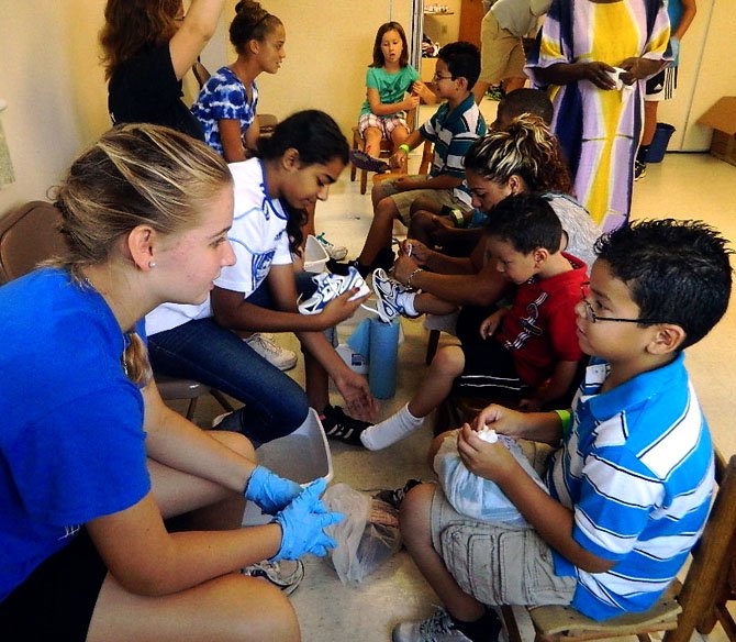 A young child hears the story of Jesus at the Last Supper washing the feet of the 12 disciples. 