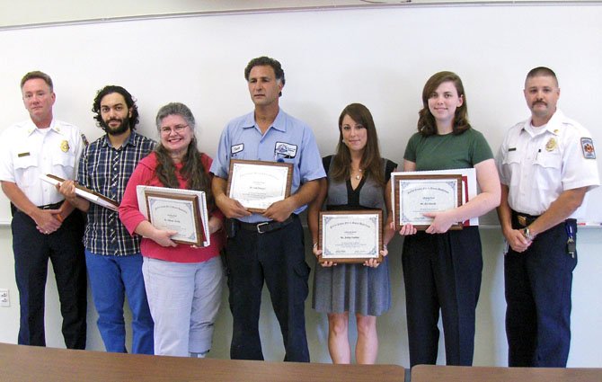 From left are Deputy Fire Chief James Walsh, Al Hussein Ahmed Wanas, Deborah Shankle, Said Ben Ayed, Ashley Osterday, Zoe Shankle and Capt. Bill Moreland at the awards ceremony.
