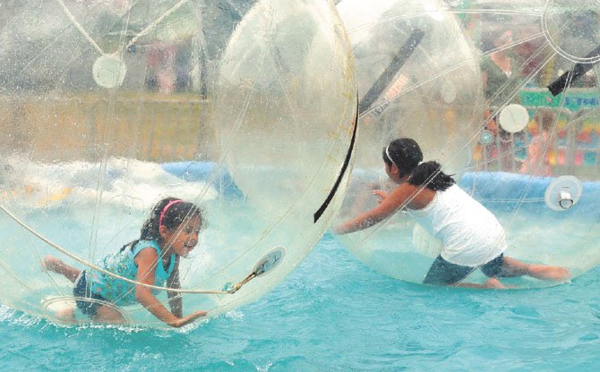 The Moyano sisters enjoyed an escape at the 2011 fair in the air bubbles above the water pond.
