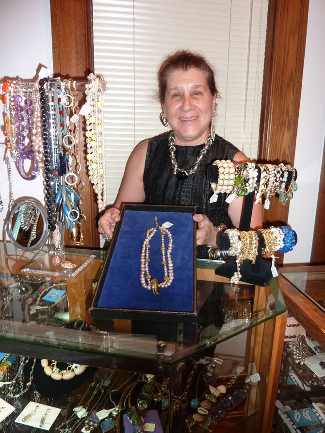 Elinor Coleman displays some of the vintage jewelry available at Vintage Mirage. After eight years on N. Lee St., the Old Town retailer reopened July 3 at 117 S. Columbus St.
