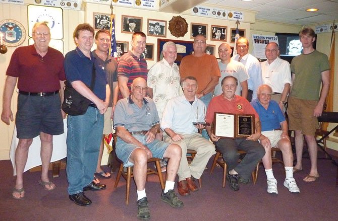 Members of American Legion Post 24 in Alexandria gather to congratulate Jim Glassman, seated second from right, on his selection as Virginia's 2012 Legionnaire of the Year. Pictured standing are (from left) Fred Brink, Erik Campbell, Eric Young, Sam Moore, Jim Taylor, Paul Moffett, Jerome Schorr, Walter Clarke, John Bordner and Eric Beckman. Seated (from left) are Warden Foley, Post 24 Commander Bill Aramony, Legionnaire of the Year Jim Glassman and Bill McNamara.
