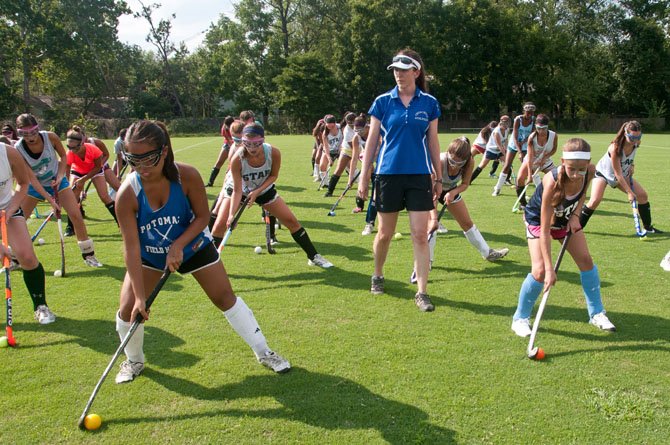 Churchill head coach Cay Miller instructs the Bulldogs during practice.