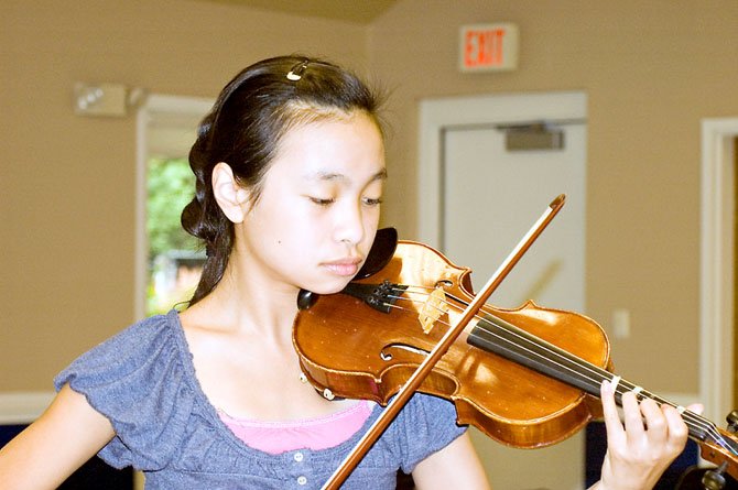 Violinist and Thoreau Middle School student Elizabeth Wu, 11, prepares her violin piece for the Summer Strings Camp final concert, held on Aug. 7.