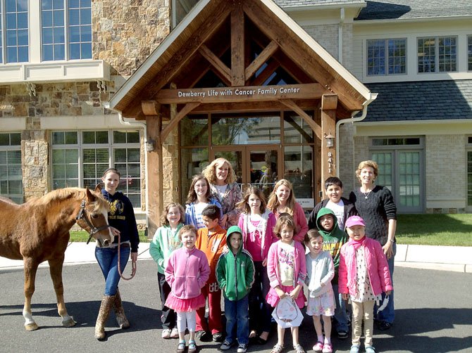 A horse and member of the Northern Virginia Therapeutic Riding Program visit children at Life with Cancer. The children pictured are a mixture of those currently battling cancer, survivors and family members.