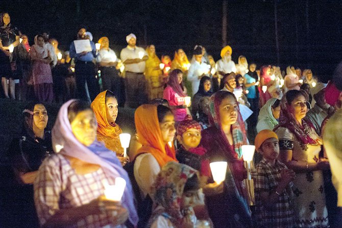 More than 300 people of all faiths gathered for a candlelight vigil at the Sikh temple in Fairfax Station on Thursday, Aug. 9, less than a week after a gunman opened fire at a Sikh temple in Wis., killing six and injuring three.