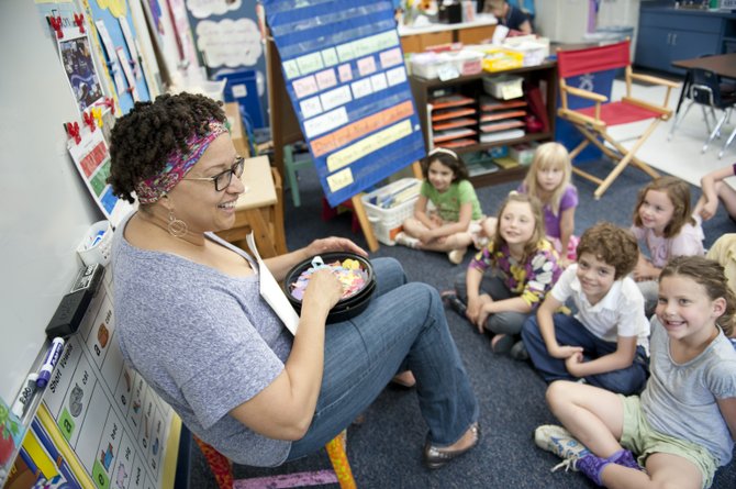 Kindergarten coordinator Cathy Gibert of the Norwood School in Potomac leads a class discussion. The final days of summer break can be an ideal time to refresh reading and math skills. 
