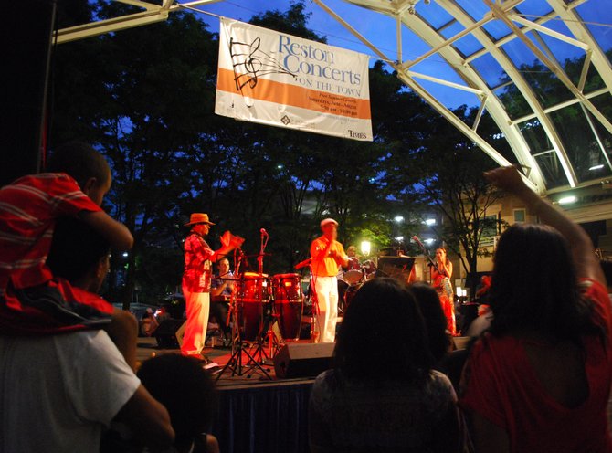 Adults and children alike groove along to the salsa and Afro-Cuban music at a Reston Town Center Concert. 