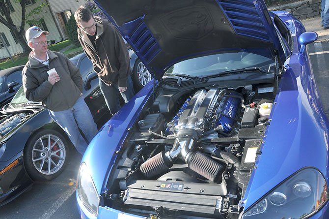 From left, Greg and Ken Fulmer examine a viper on display at Cars and Coffee. 