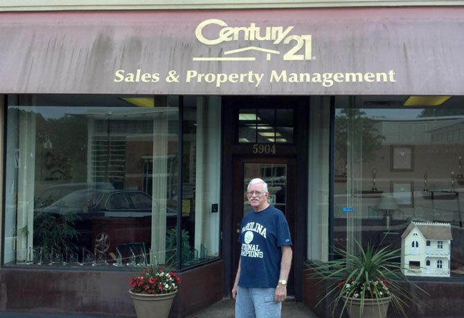 Perry Gawen standing in front of the business his father started as a one man office in 1969, he joined full time in 1973 and retired from it in 1998.
