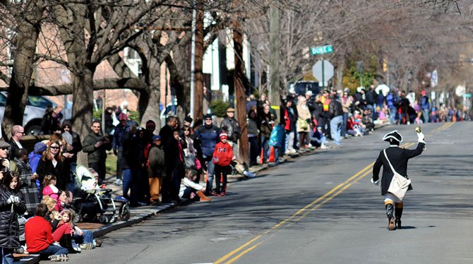 Alexandria Town Crier Ben Fiorre-Walker leads the annual George Washington Birthday parade up S. Fairfax Street.