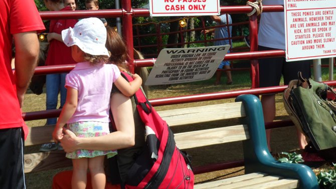 Resident Edina Komlodi, with her daughter, awaits the pony ride at the County Fair.