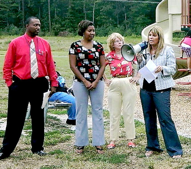 Crystal Compton appeals for a safe practice field at Muddy Hole Farm. At left is Coach Ricky Hairston.