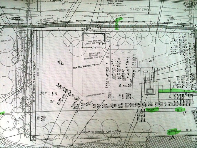 Detailed construction plans of Contrabands and Freedmen's Cemetery: Ovoid shapes with Rectangle inlays indicate known grave sites and place markers in position. Larger rectangle shapes in photo represent remnants of office building and gas station.