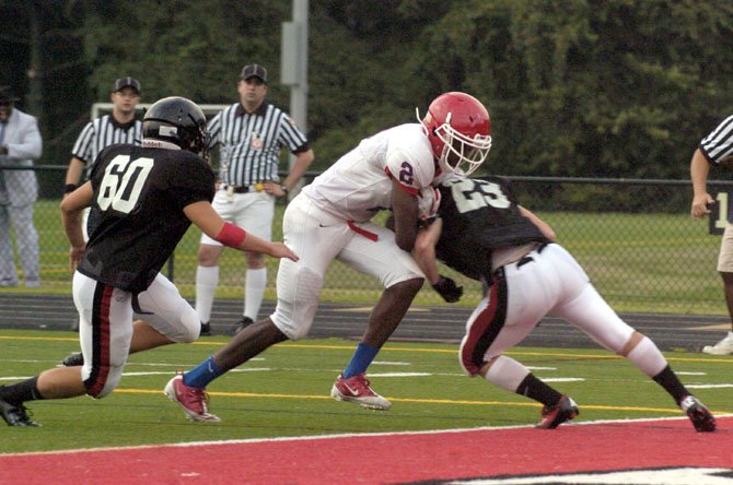 T.C. Williams senior receiver Landon Moss scores the first of his two touchdowns during a scrimmage against Herndon on Aug. 23.