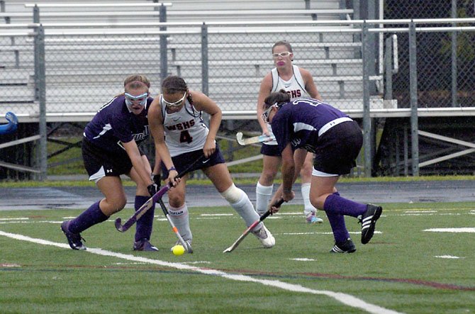 West Springfield senior Tasy Novopachennaia battles for the ball against two Chantilly players during the “Under the Lights” field hockey tournament on Aug. 25 at Lee High School.