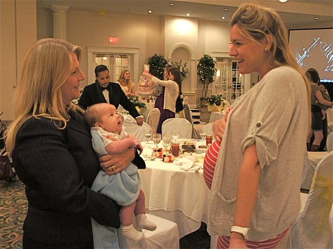 Virginia's First Lady Maureen McDonnell handles 7-week-old Connor Paszkiet like the pro that she is, having raised five of her own. Alana Dickenson, expecting her first, was no doubt picking up some helpful hints. Connor's mom couldn't get in the photo, as she was busy chasing Connor's 13-month-old sister, Kairi.
