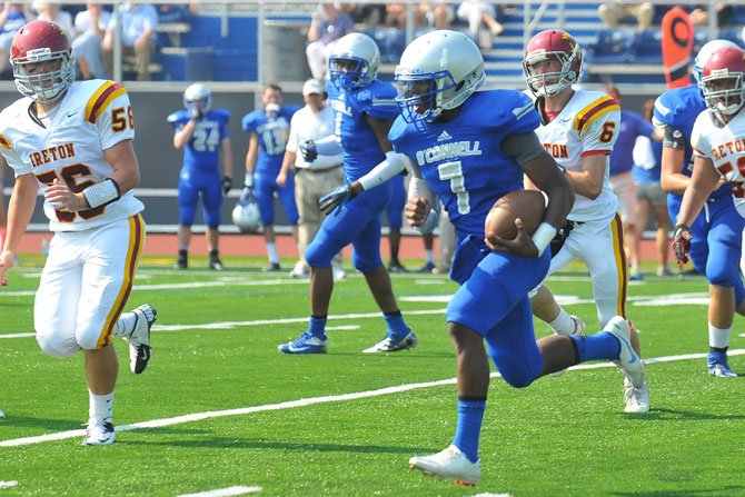 Bishop O’Connell quarterback Leighton Dassau runs with the ball while pursued by Bishop Ireton lineman Tommy Putzu (56) during the team’s matchup on Aug. 31 in Arlington.