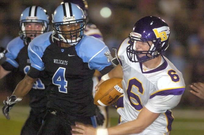 Centreville’s Xavier Nickens-Yzer (4) chases after Lake Braddock quarterback Caleb Henderson on Aug. 31 at CHS.