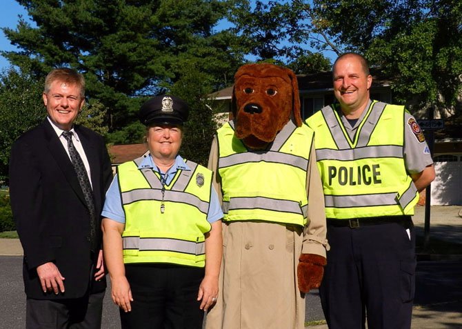 (From left) Supervisor John Cook, Shirley Hanson, the Laurel Hill Elementary School crossing guard,
 McGruff and J.T. Frey of the West Springfield Police Station.