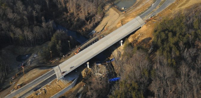 A view of the North Loop Road Bridge as it crosses over the construction of a Coffer Dam at Accotink Creek at the National Geospatial-Intelligence Agency Campus East project.