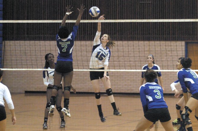 Senior middle hitter Mary Severin (15) and the South Lakes volleyball team faced Forest Park in the semifinals of the Hayfield Invitational on Sept. 29.