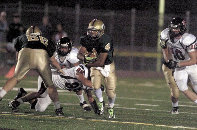 Langley running back Philip Mun rushed for 221 yards on Sept. 28, but it was Madison’s Ben Sanford, right, who led the Warhawks to victory with three interceptions and two touchdowns.